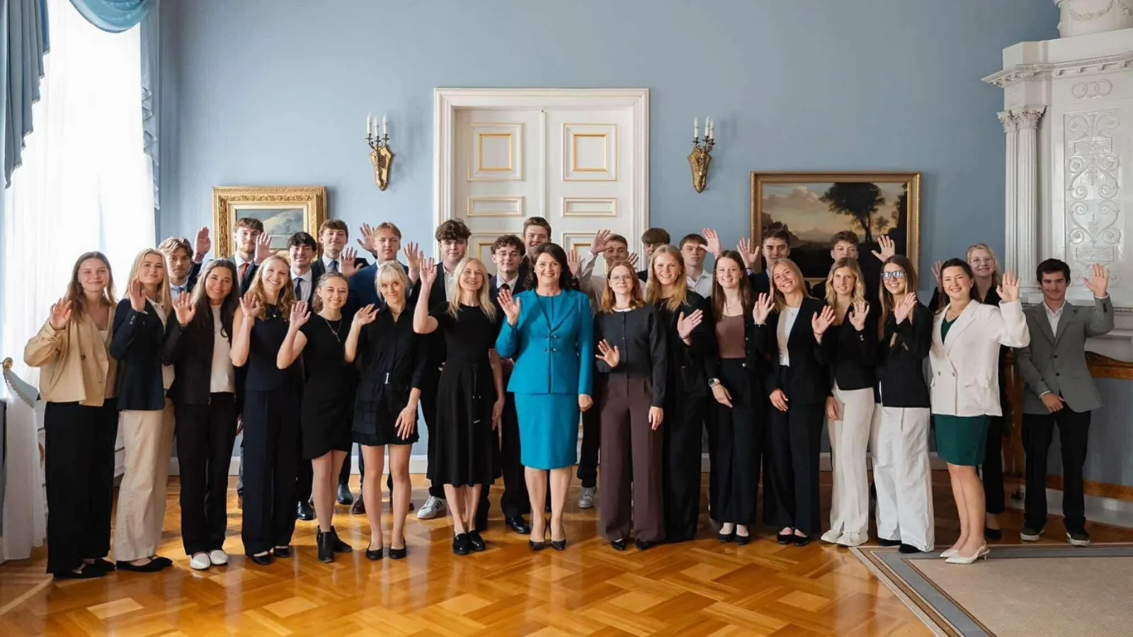 A large group of student interns inside of a government building in Vilnius, Lithuania