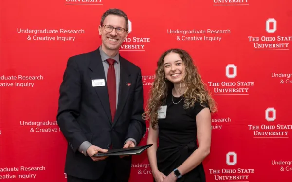 An International Studies major receiving an award at the Denman Research Forum